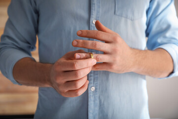 a man removing his wedding ring for a divorce