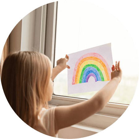 child with drawing of rainbow