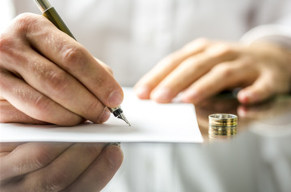 wife signing a divorce paper